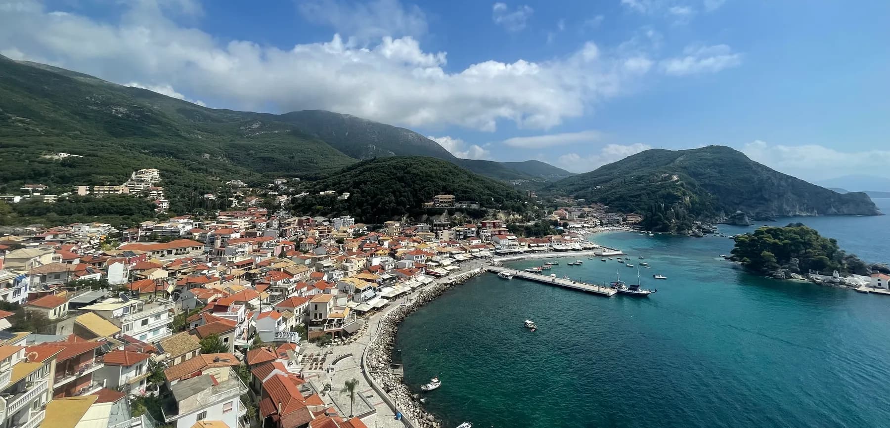 Parga harbour with colourful houses and the Venetian castle on the headland